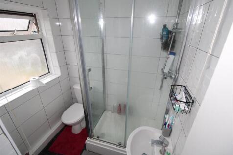 Bright bathroom with modern glass shower cubicl...