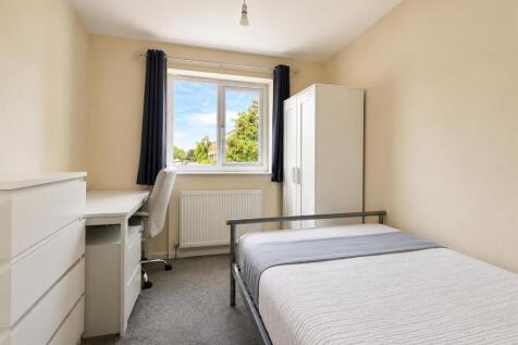 Bright bedroom with study area and ample storag...