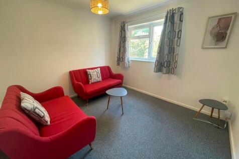 Bright, neatly presented living room with match...