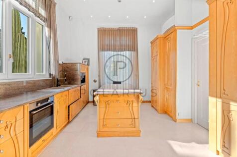 Bright kitchen with wooden cabinetry, a central is