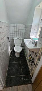 Bright cloakroom with window and modern basin...