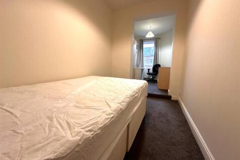 Bright, simply furnished bedroom with a comfort...