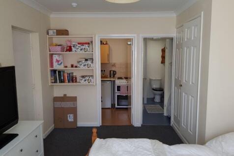 Bright bedroom with built-in storage and ensuit...