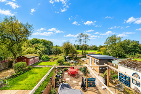 Vibrant Garden Retreat with Red Seating.png