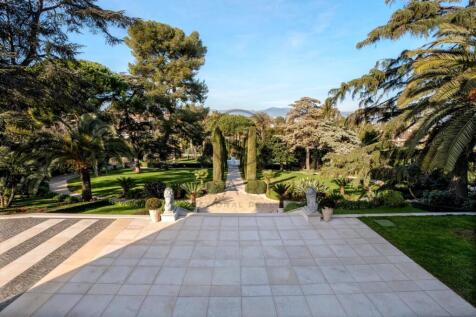 A spacious terrace leads to a lush, well-maintaine