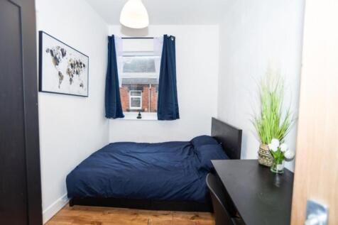 This cozy double bedroom features a comfortable...