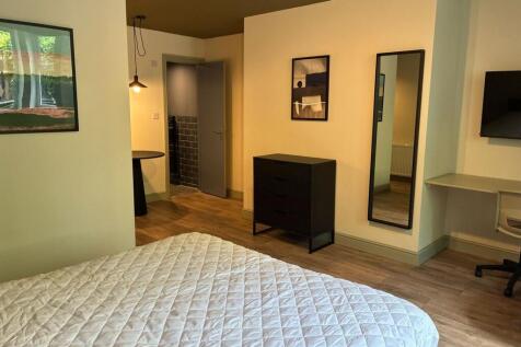 Stylish modern bedroom with integrated desk are...