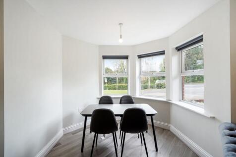 Bright dining area with large bay windows...