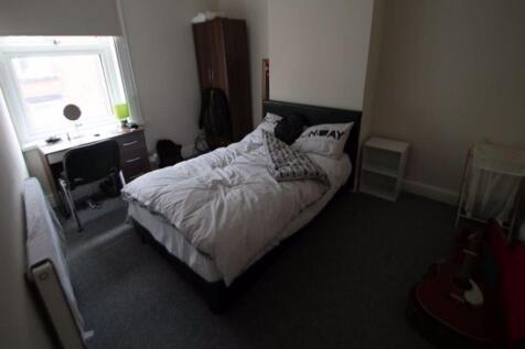 A cozy and well-maintained bedroom featuring a ...