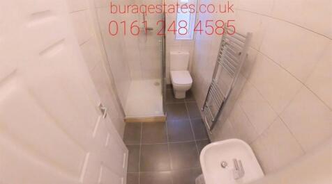 Compact, modern bathroom with white sanitarywar...