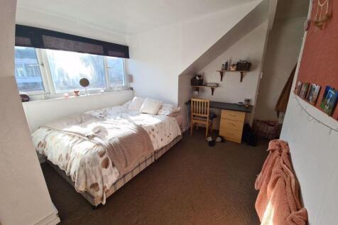 Bright and cozy double bedroom featuring a larg...