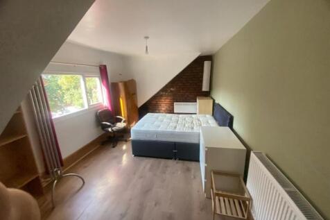 Bright furnished bedroom with a double bed, war...