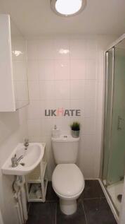 Bright and tidy bathroom featuring a compact to...