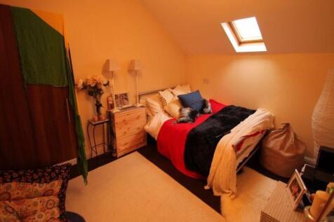 A spacious master bedroom featuring a large dou...