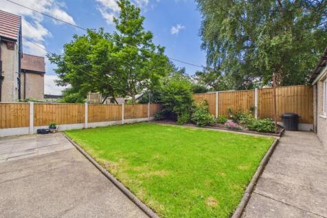 Private lawned garden with patio and mature planting