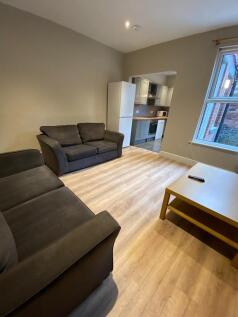 Bright, modern living room with two comfortable...