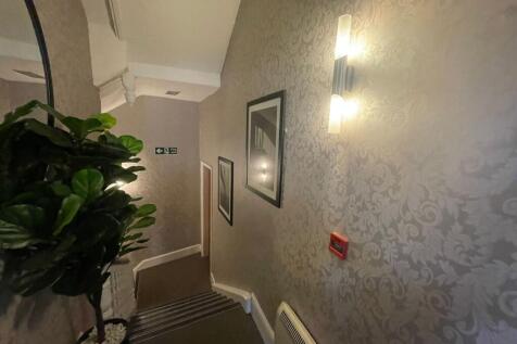 Elegant staircase with stylish damask wallpaper...