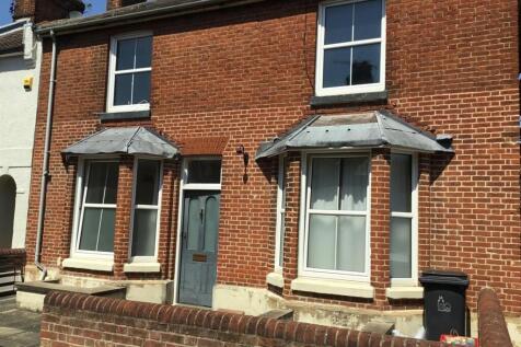 Charming red brick home with large bay windows...