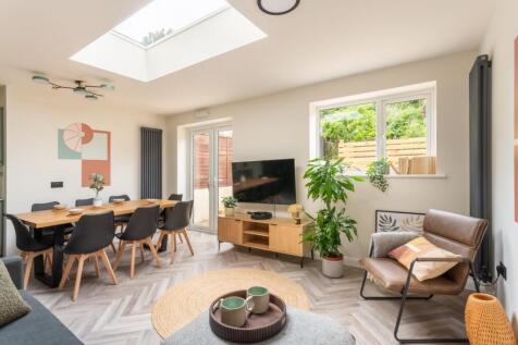 Sun-drenched modern lounge with skylight...