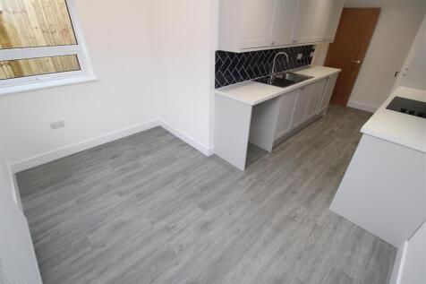 Bright modern kitchen with stylish wood floorin...