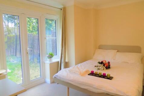 A bright double bedroom featuring a comfortable...