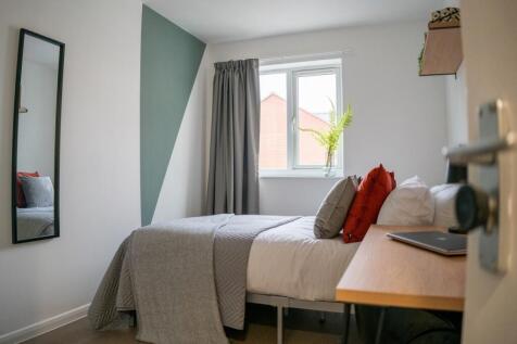 A bright, well-maintained master bedroom featur...