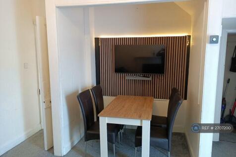 Tv Wall And Dining Area With Large Tv