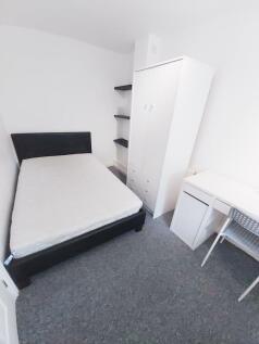 Bright, simply furnished double bedroom with a ...