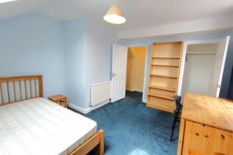 Bright, freshly painted double bedroom with blu...