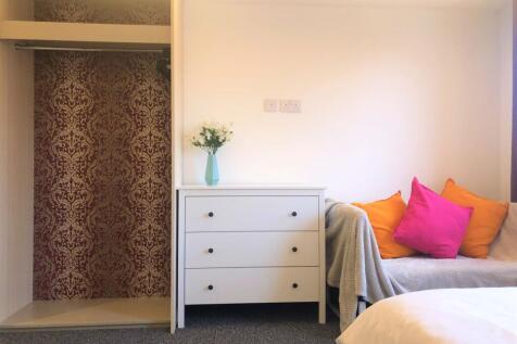 Bright and cozy double bedroom featuring a clea...