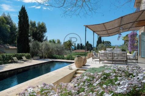 A serene outdoor patio with comfortable seating ov