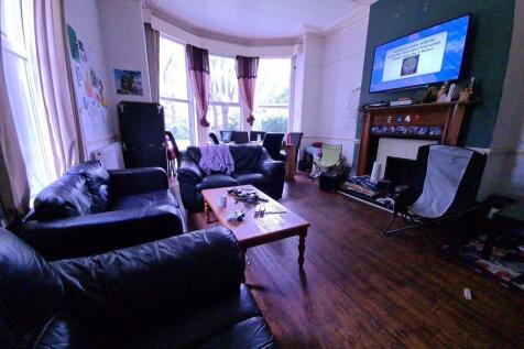 A charming living room featuring a bay window w...