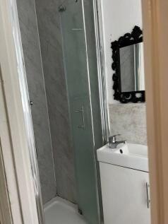 Modern shower room with ornate feature mirror...