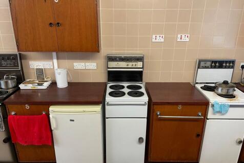 Well-equipped communal kitchen area with multip...