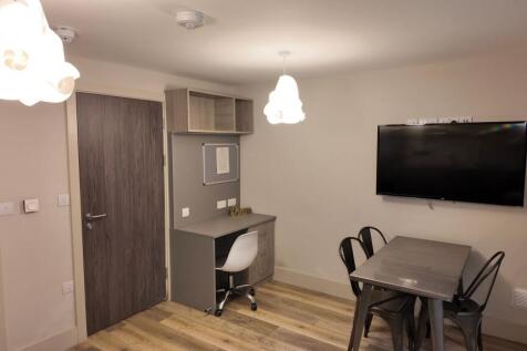 Bright, modern communal lounge with a wall-moun...