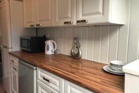 A well-maintained kitchen featuring a spacious ...