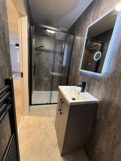 Contemporary bathroom with a walk-in glass show...