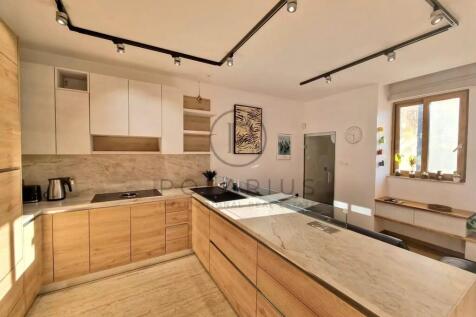 Modern kitchen with wood and white cabinetry, marb
