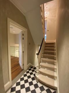 Well-maintained entrance stairway with patterne...