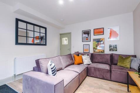 Modern living area with a plush corner sofa...
