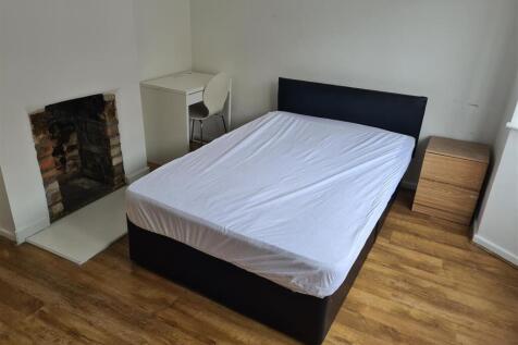 Bright bedroom with double bed and desk area...