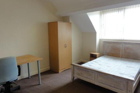 Bright and simply furnished bedroom with a doub...