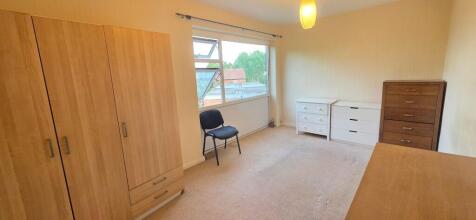 Bright bedroom with ample storage and large win...
