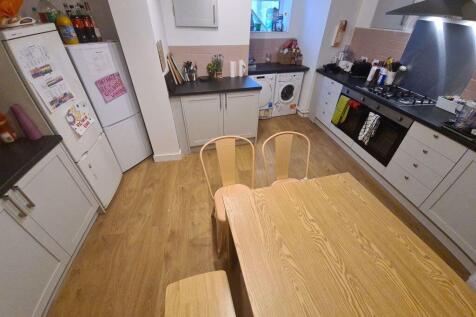 A bright, modern kitchen with ample counter spa...