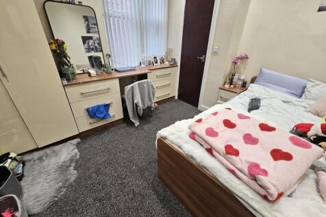 A spacious and inviting master bedroom featurin...