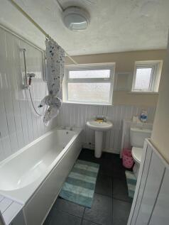 Bright bathroom suite with bath and windows...