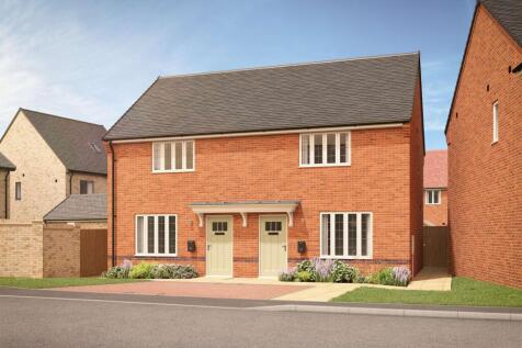 A pair of modern brick semi-detached houses with manicured gardens and a paved driveway are set agai