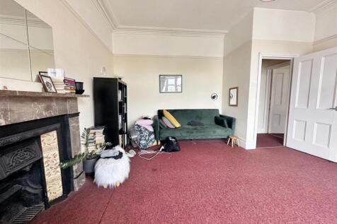Spacious living area with character fireplace...