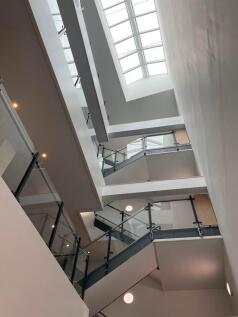 Modern multi-storey interior atrium with glass-...