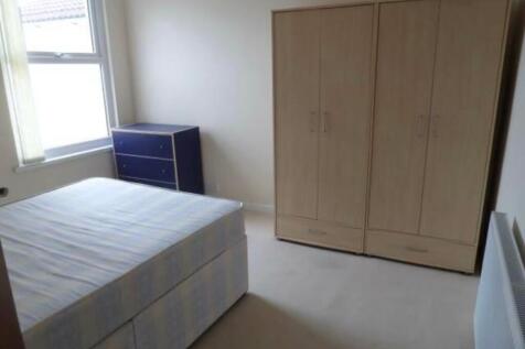 Bright furnished bedroom with a double divan be...